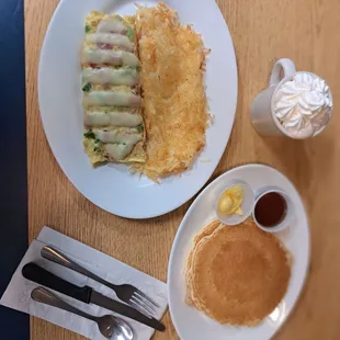 a plate of pancakes, a plate of pancakes, and a cup of coffee