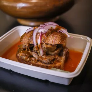 a sandwich with onions and meat