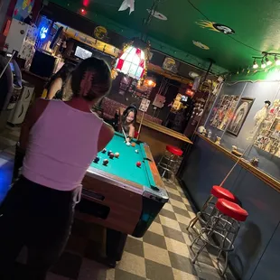 a woman playing a game of pool