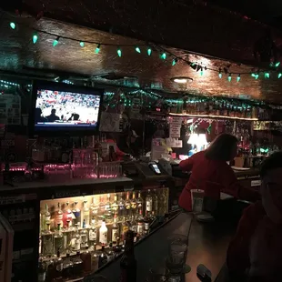 a bar with a television and a lot of liquor