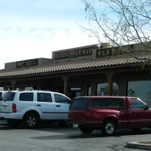 two trucks parked in front of the building