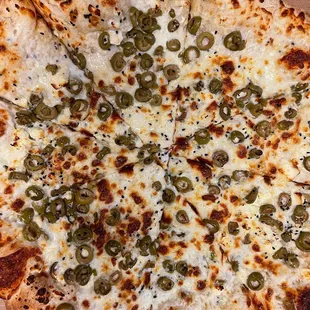 a pizza with olives and cheese