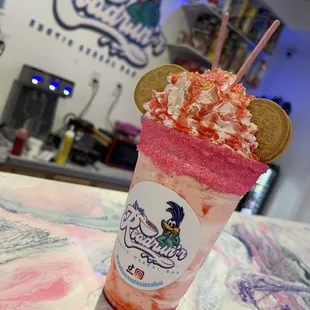 a strawberry milkshake with a cookie on top