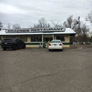 a car parked in front of a restaurant