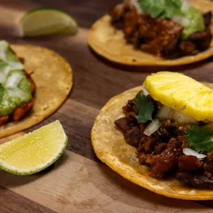 three tacos on a cutting board
