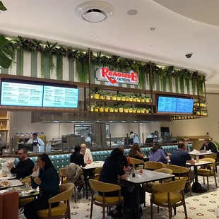 people sitting at tables in a restaurant