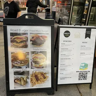 a menu and a sign on the sidewalk