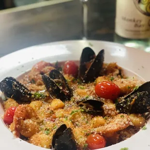 a plate of food and a glass of wine