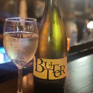 a bottle of beer and a glass of wine