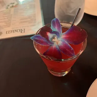 a drink with a purple flower