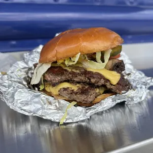 a hamburger with cheese and lettuce