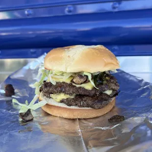 a hamburger on a piece of tin foil