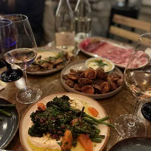 a table of food and wine glasses