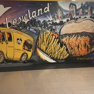 A beautiful picture of our famously known food truck painted on a mural of E.185th. HOME OF THE GUSHERBURGER