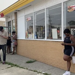 Customers waiting outside to eat a delicious Gusherburger or, wings, tacos, polish boys... RoamingMeals Home Of The Gusherburger