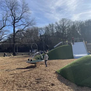 The cool playground w big slides, zip line, wide slide