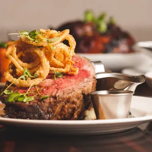 a steak with onion rings on top