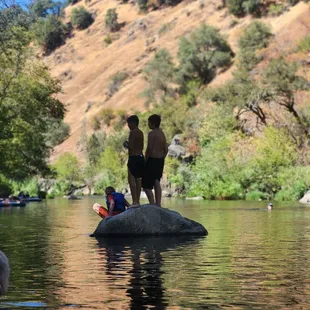 Kids swimming at the swimming hole.