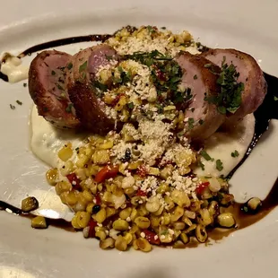 Bacon wrapped pork tenders with street corn over cheese grits