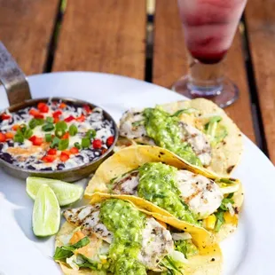 a plate of tacos and a drink