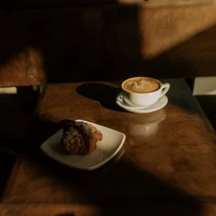 a plate of croissants and a cup of cappuccino