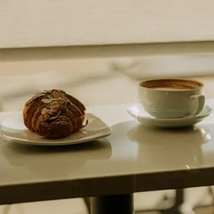 a croissant and a cup of coffee