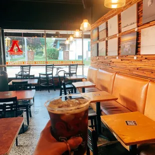 a hand holding a cup of coffee