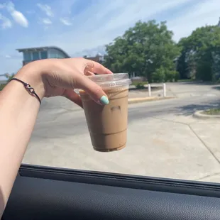a hand holding a cup of coffee