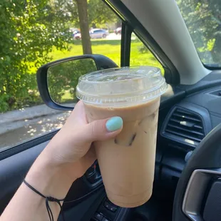 a hand holding a cup of coffee