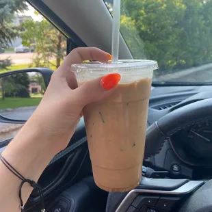 a hand holding a cup of coffee