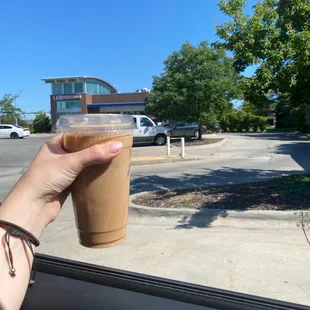 a hand holding a cup of coffee