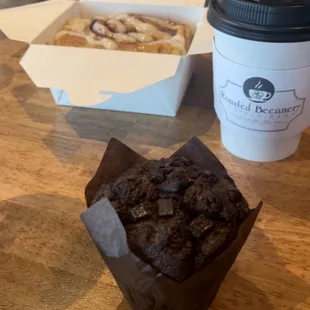 Chocolate muffin, cinnamon roll, and coffee.