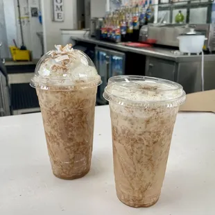 Two iced Chai Horchata Breve, left topped with whipped cream, right topped with sweet cream