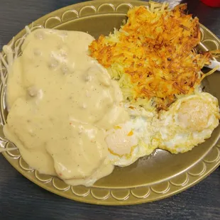 Biscuits and sausage gravy meal with hash browns and 2 eggs
