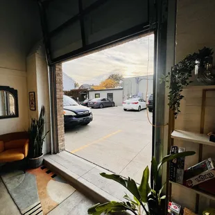 a view of a parking lot through a garage door