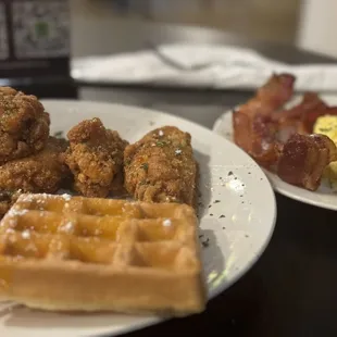 Chicken and waffles, bacon and eggs.