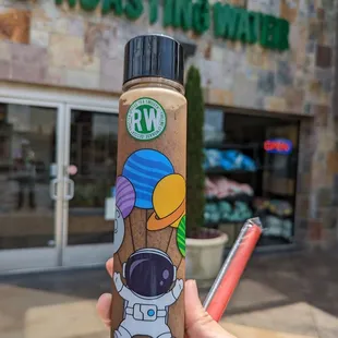 a hand holding a water bottle