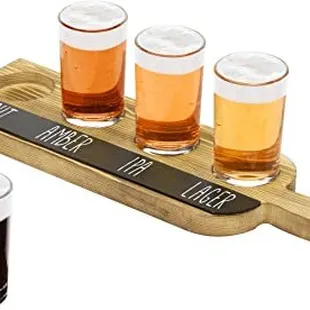 four glasses of beer on a wooden serving board