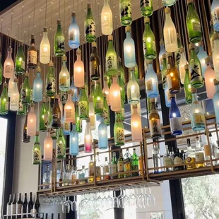Sake bottle lights display above the bar