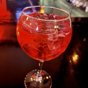 a red drink in a wine glass