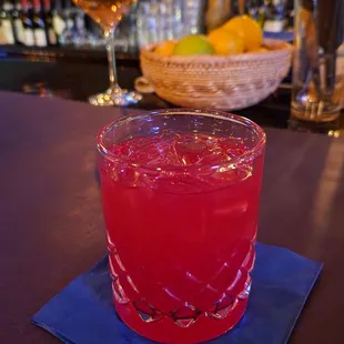 a drink in a glass on a blue napkin