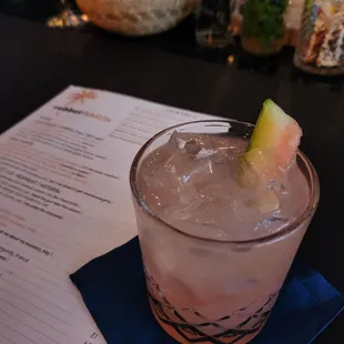 a drink with a slice of watermelon