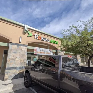 a truck parked in front of a store