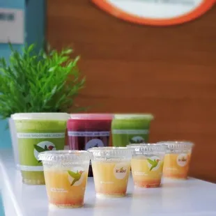 a variety of juices in plastic cups