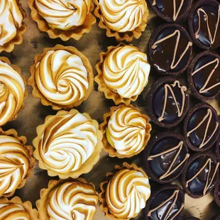 We love our sweets! Bite-size sea salt caramel chocolate tarts and lemon meringue tartlets.
