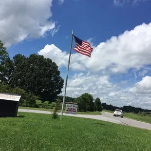 ows an american flag flying in the wind