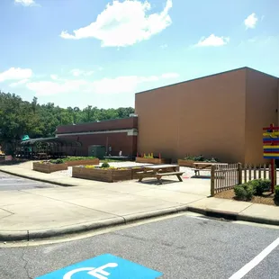 Side of the building includes small community garden, sidewalk games and playground, great for the kids camps they offer.