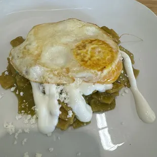 Buffet chillequilles with green salsa and an added over easy egg