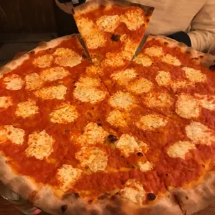 a person cutting into a pizza