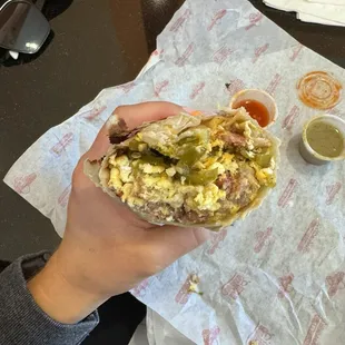Sausage, bacon, egg, and cheese breakfast burrito add potatoes and jalapeños. ($0.89 per extra side).
